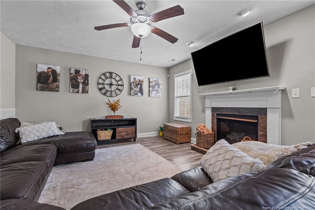 263 Autumn Ln, Raeford, NC 28376 - living room with wood finished floors, ceiling fan, a fireplace, and baseboards