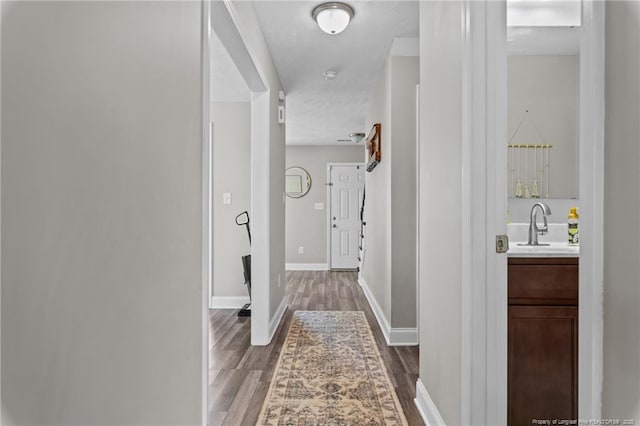 263 Autumn Ln, Raeford, NC 28376 - hallway with wood finished floors, a sink, and baseboards