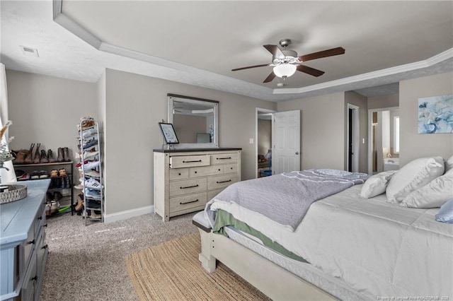 263 Autumn Ln, Raeford, NC 28376 - bedroom with a tray ceiling, light carpet, baseboards, a ceiling fan, and connected bathroom