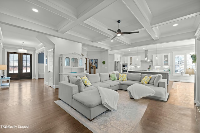 76 Gentry Dr, Pittsboro, NC 27312 - living room with ceiling fan, wood finished floors, beamed ceiling, and a wealth of natural light