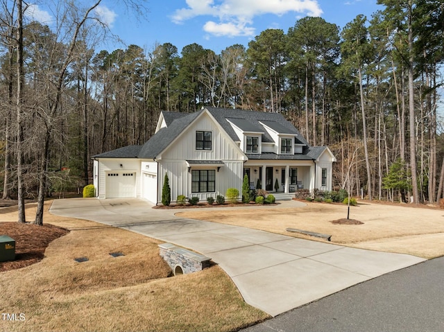 76 Gentry Dr, Pittsboro, NC 27312 - modern inspired farmhouse featuring a garage, board and batten siding, driveway, covered porch, and a shingled roof