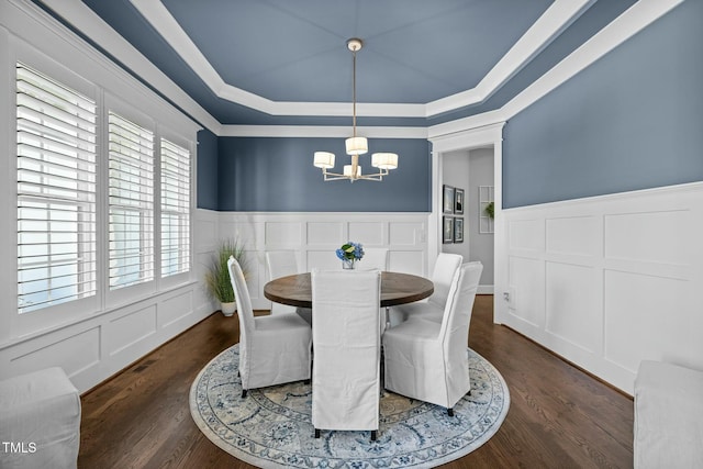 76 Gentry Dr, Pittsboro, NC 27312 - dining space featuring a raised ceiling, dark wood-style flooring, a notable chandelier, and wainscoting