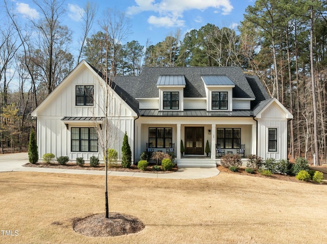 76 Gentry Dr, Pittsboro, NC 27312 - modern farmhouse with board and batten siding, a standing seam roof, roof with shingles, and metal roof