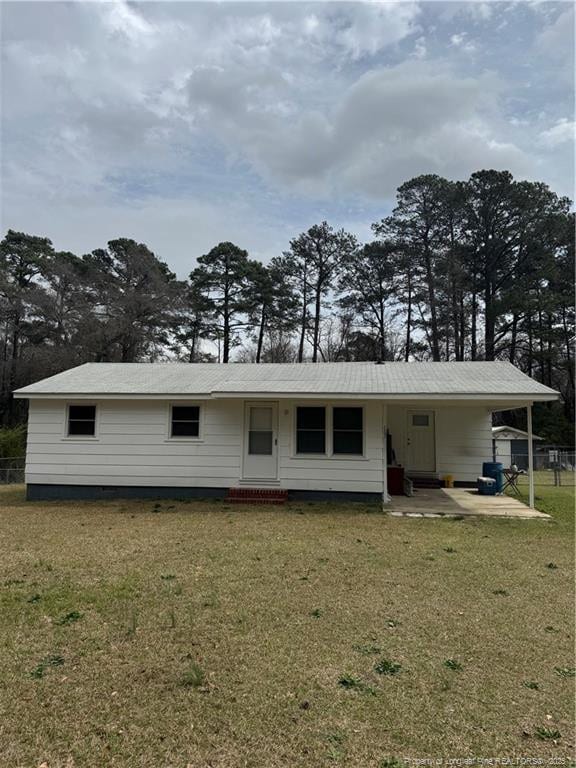 2907 George Owen Rd, Fayetteville, NC 28306 - back of property featuring an attached carport, a yard, and entry steps