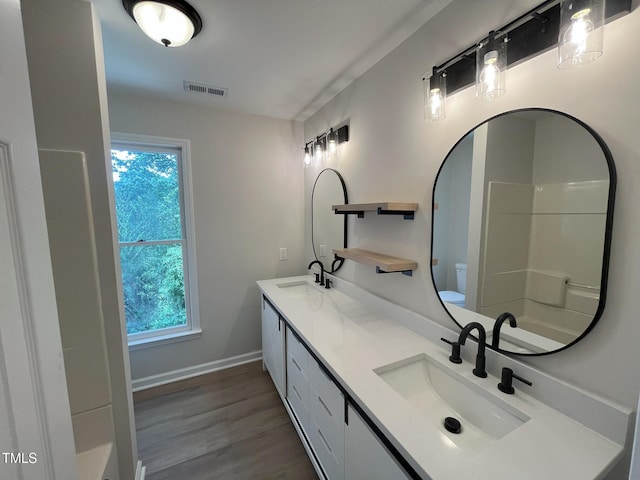 1116 Shadywood Ln, Raleigh, NC 27603 - full bath featuring double vanity, wood finished floors, toilet, and baseboards