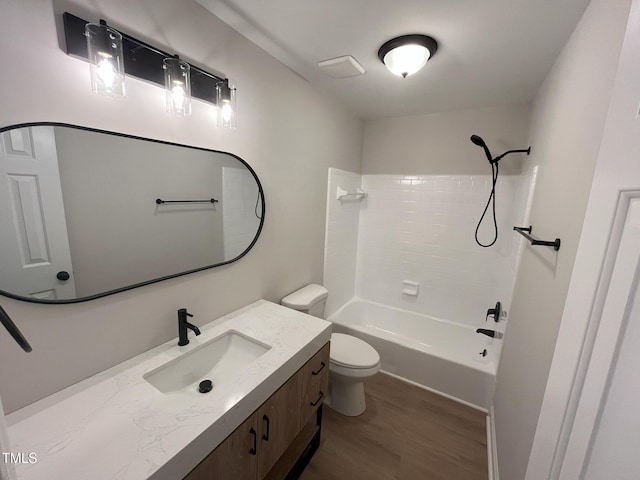 1116 Shadywood Ln, Raleigh, NC 27603 - full bathroom featuring vanity, toilet, wood finished floors, and shower / washtub combination