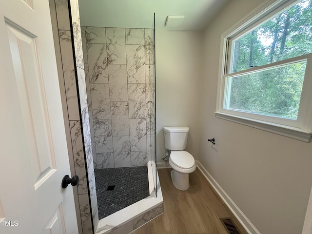 1116 Shadywood Ln, Raleigh, NC 27603 - bathroom featuring toilet, wood finished floors, a stall shower, and baseboards
