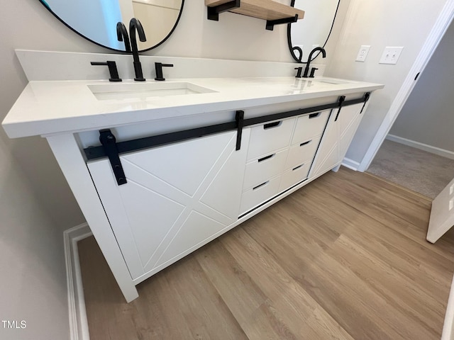 1116 Shadywood Ln, Raleigh, NC 27603 - full bath featuring double vanity, wood finished floors, and baseboards