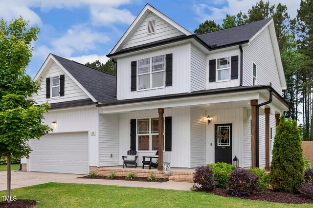 view of front of home featuring covered porch, driveway, and roof with shingles