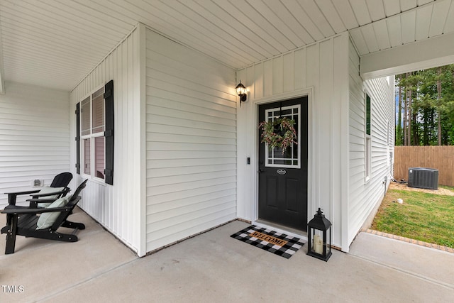 doorway to property with central air condition unit and fence