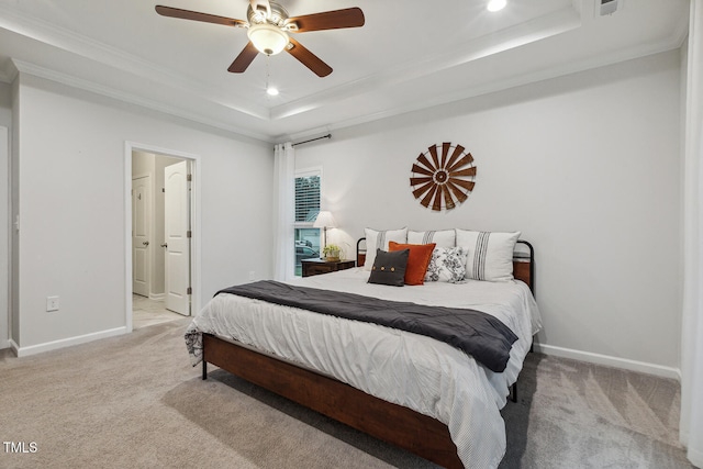 carpeted bedroom with a tray ceiling, baseboards, crown molding, recessed lighting, and a ceiling fan