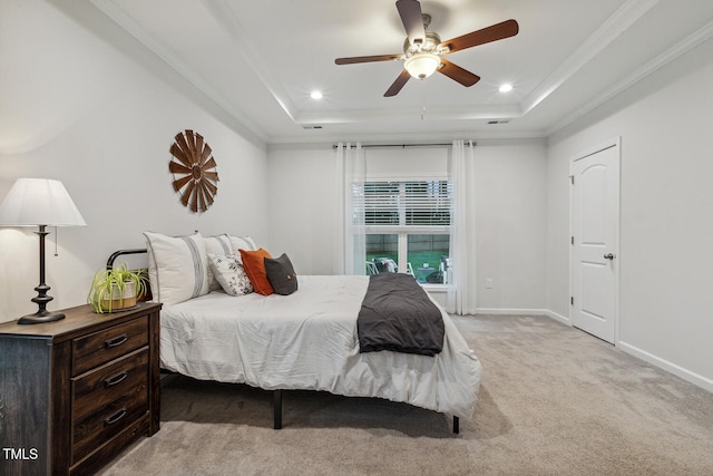 bedroom featuring a tray ceiling, light carpet, baseboards, recessed lighting, and crown molding