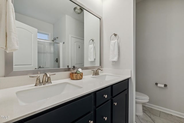 bathroom featuring baseboards, a shower stall, marble look tiles, toilet, and double vanity