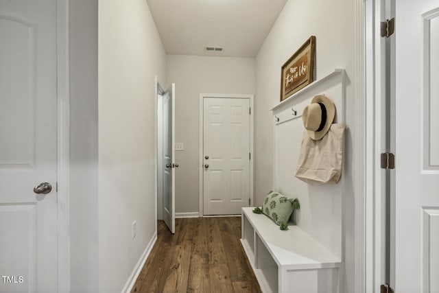 mudroom featuring dark wood finished floors and baseboards
