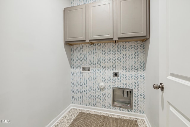 laundry room with electric dryer hookup, cabinet space, hookup for a washing machine, and baseboards