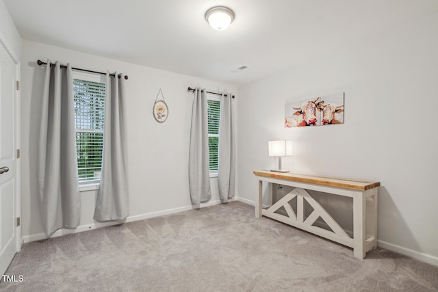 carpeted office space featuring baseboards