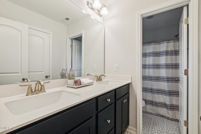 bathroom featuring double vanity, toilet, and a shower with shower curtain