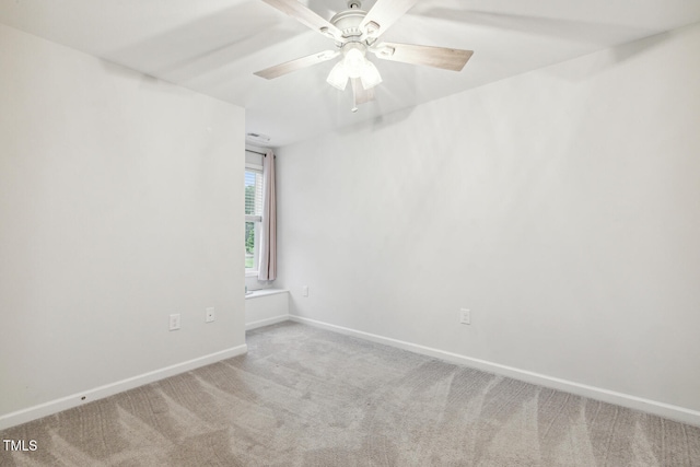 spare room featuring carpet floors, baseboards, and ceiling fan