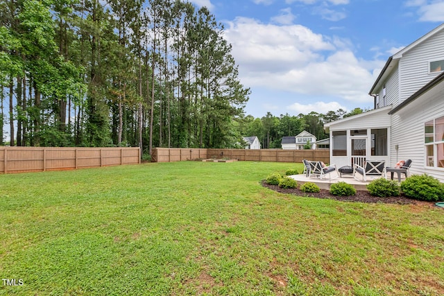 view of yard featuring a sunroom and a patio area