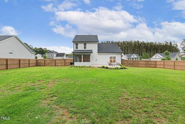 back of property with a sunroom and a shingled roof