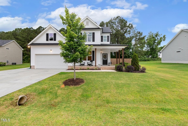 view of front of house featuring covered porch, driveway, board and batten siding, a front lawn, and a garage