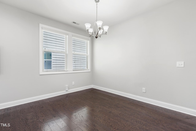 109 Belle Plain Dr, Morrisville, NC 27560 - spare room with dark wood-style flooring, a chandelier, and baseboards
