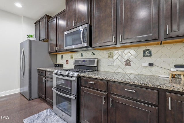 109 Belle Plain Dr, Morrisville, NC 27560 - kitchen with appliances with stainless steel finishes, tasteful backsplash, light stone countertops, baseboards, and dark wood finished floors