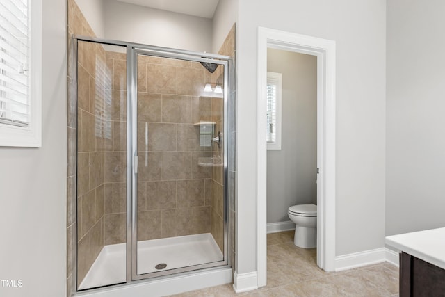 109 Belle Plain Dr, Morrisville, NC 27560 - bathroom featuring a stall shower, toilet, baseboards, tile patterned flooring, and vanity