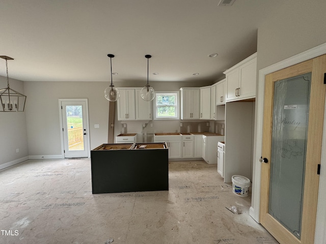 9600 Stallings Rd, Spring Hope, NC 27882 - kitchen featuring a center island, white cabinetry, and hanging light fixtures