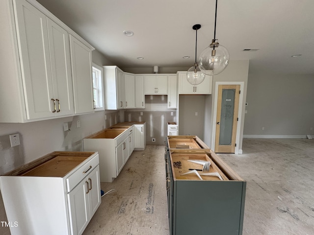 9600 Stallings Rd, Spring Hope, NC 27882 - kitchen with a kitchen island, white cabinets, hanging light fixtures, recessed lighting, and baseboards