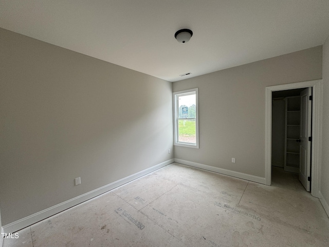 9600 Stallings Rd, Spring Hope, NC 27882 - unfurnished bedroom featuring baseboards and a walk in closet