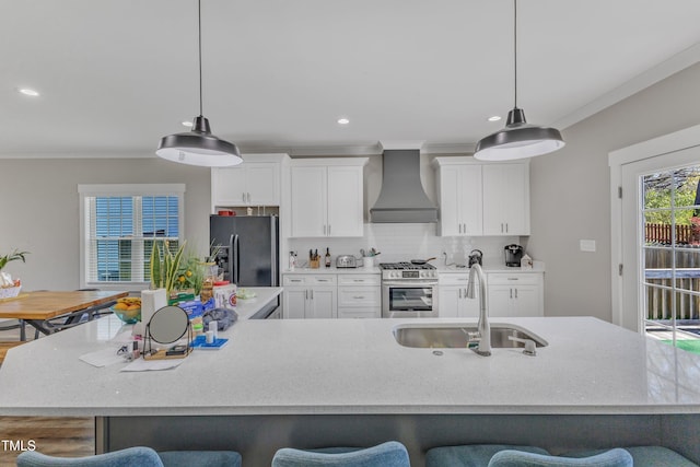 kitchen featuring gas range, black fridge with ice dispenser, a sink, premium range hood, and a breakfast bar area