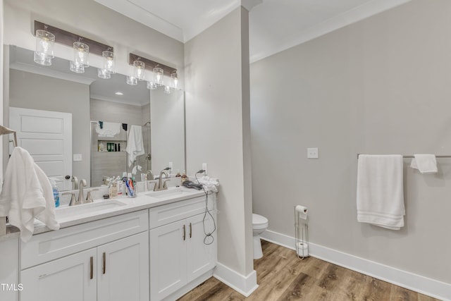 full bathroom featuring a sink, toilet, a shower stall, and crown molding