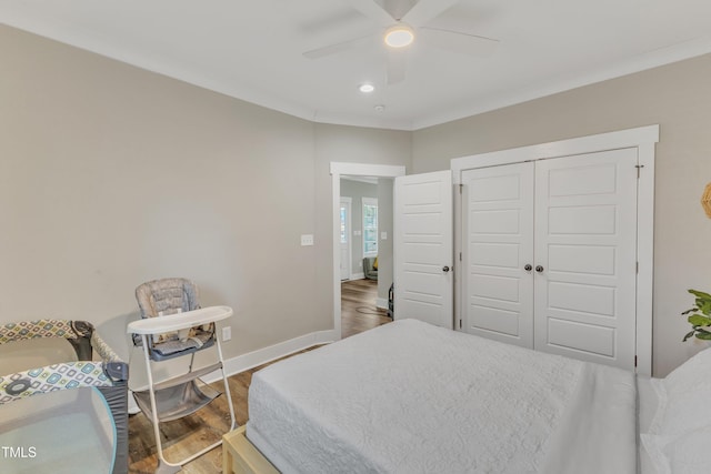 bedroom featuring a closet, baseboards, recessed lighting, ceiling fan, and wood finished floors
