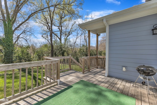 wooden deck featuring a grill