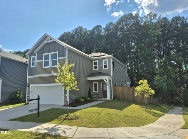 4000 Passenger Pl, Durham, NC 27703 - view of front of home featuring an attached garage, concrete driveway, stone siding, and board and batten siding
