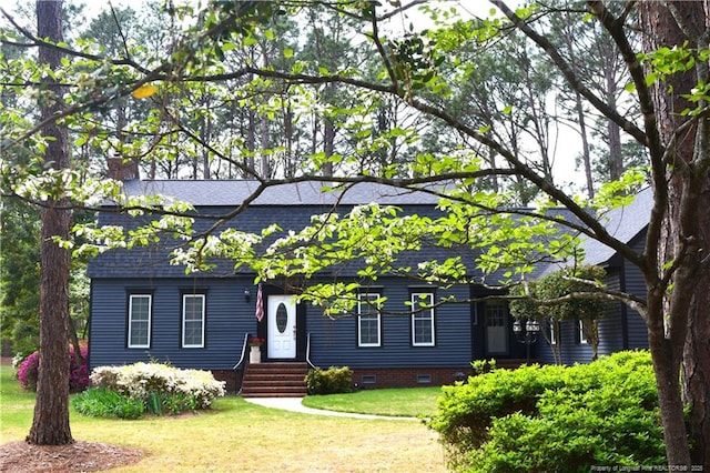 view of front of house featuring a front yard, crawl space, and a shingled roof