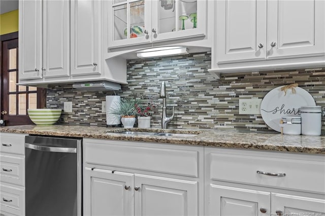 kitchen featuring a sink, backsplash, white cabinetry, and dishwashing machine