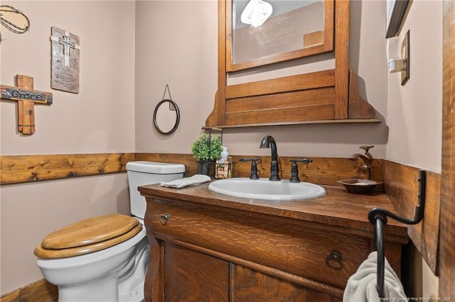 half bath featuring toilet and vanity