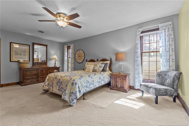 carpeted bedroom featuring a textured ceiling, baseboards, and visible vents