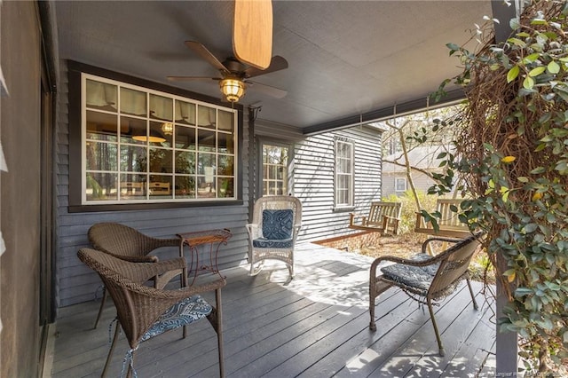 wooden terrace featuring ceiling fan