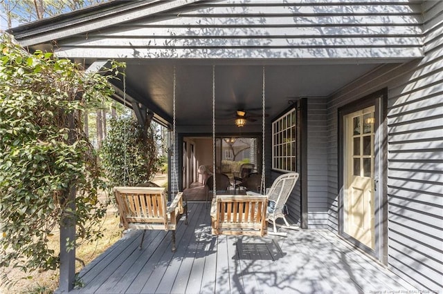 wooden deck with an outdoor living space and ceiling fan