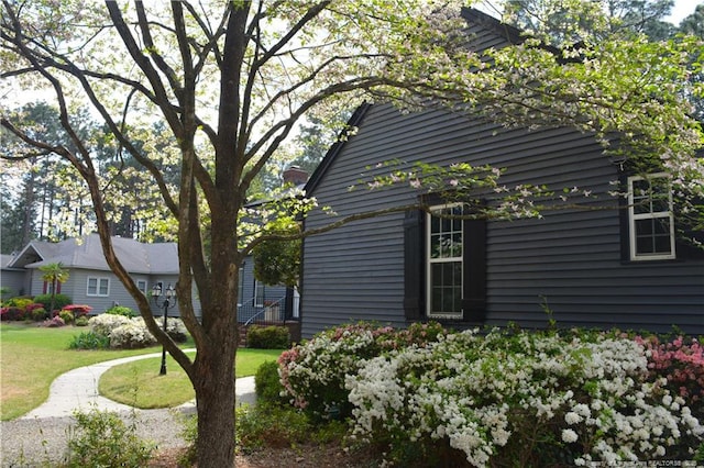 view of side of home featuring a yard