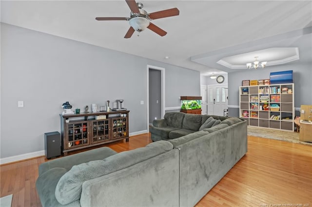 33 Woodbury Ln, Sanford, NC 27332 - living area featuring ceiling fan with notable chandelier, wood finished floors, baseboards, and a raised ceiling