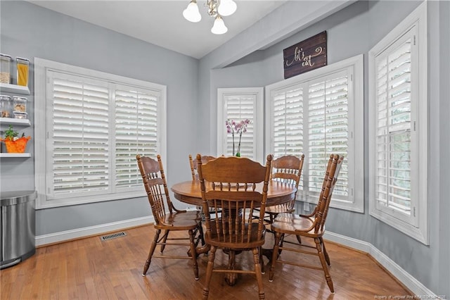 33 Woodbury Ln, Sanford, NC 27332 - dining space featuring baseboards, wood finished floors, visible vents, and a notable chandelier