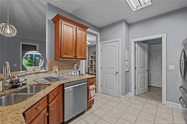33 Woodbury Ln, Sanford, NC 27332 - kitchen with brown cabinetry, light tile patterned floors, stainless steel appliances, and a sink