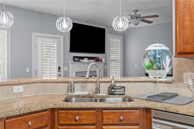 33 Woodbury Ln, Sanford, NC 27332 - kitchen featuring a sink, brown cabinetry, ceiling fan, backsplash, and dishwashing machine