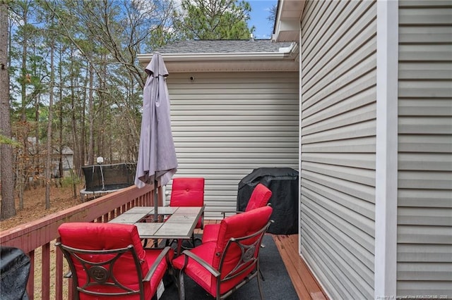 33 Woodbury Ln, Sanford, NC 27332 - wooden terrace with outdoor dining space and a trampoline