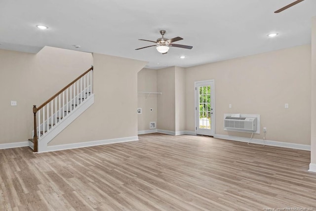 432 Timberline Dr, Fayetteville, NC 28311 - unfurnished living room featuring a ceiling fan, light wood-style floors, a wall mounted AC, stairway, and recessed lighting