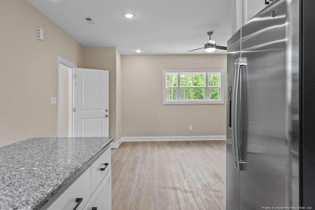 432 Timberline Dr, Fayetteville, NC 28311 - kitchen with stainless steel refrigerator with ice dispenser, ceiling fan, white cabinets, light wood-style floors, and light stone counters